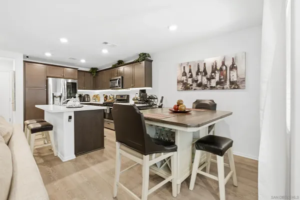 a kitchen with stainless steel appliances kitchen island granite countertop a sink and cabinets