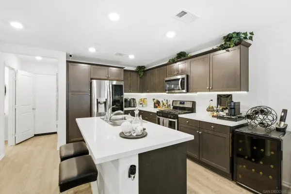 a kitchen with a sink stainless steel appliances and cabinets