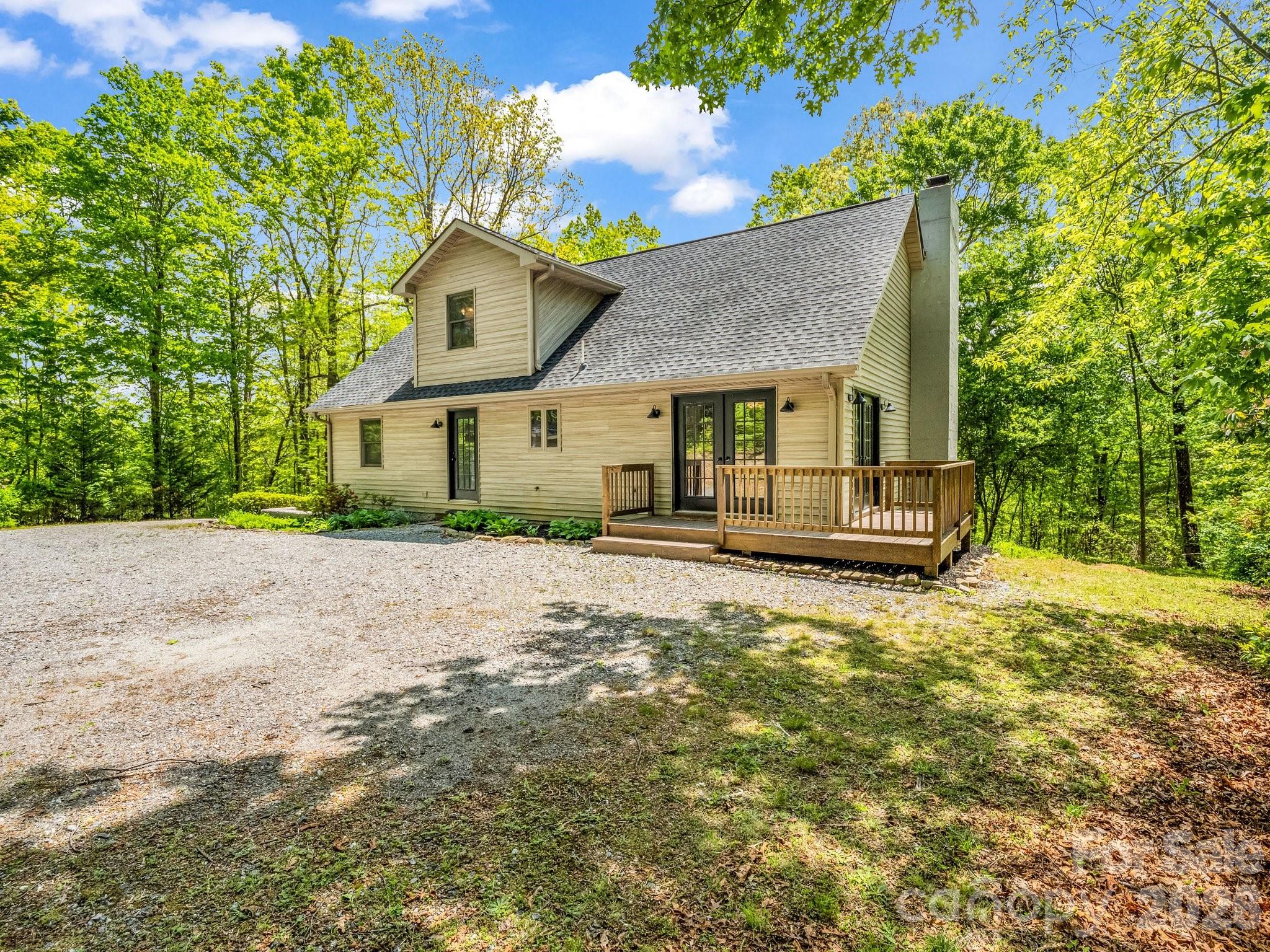 2304 Mountain Page Road Saluda, NC 28773 - Photo 3 of 38 a house with trees in the background