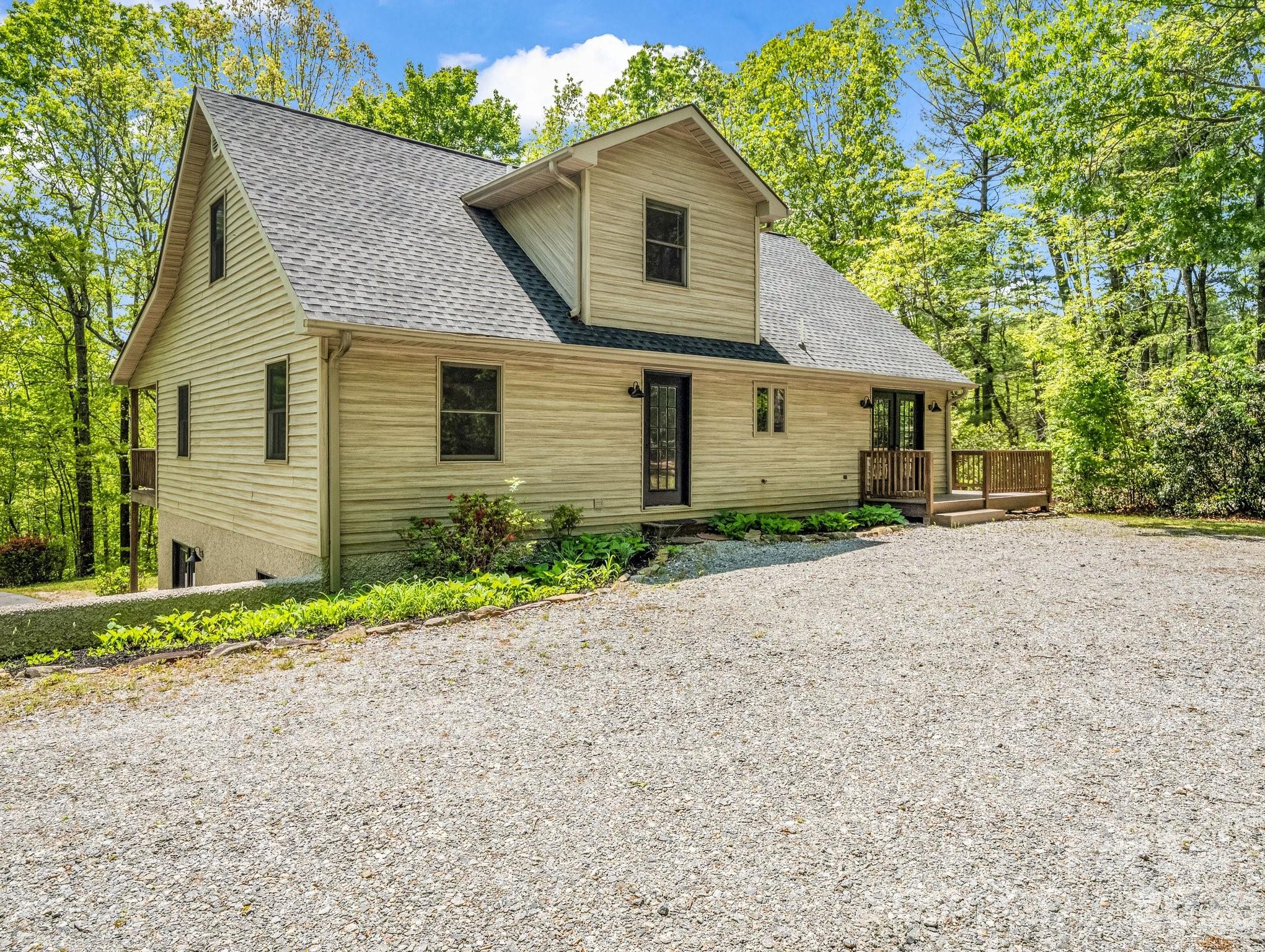 2304 Mountain Page Road Saluda, NC 28773 - Photo 4 of 38 a front view of a house with a yard and garage