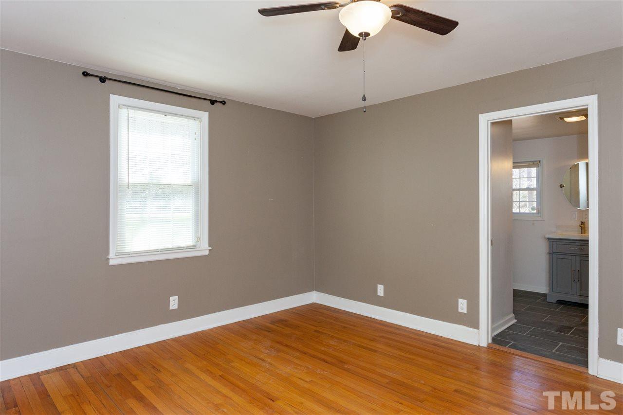 10819 North Roxboro Street Rougemont, NC 27572 - Photo 5 of 25 a view of an empty room with wooden floor and a window