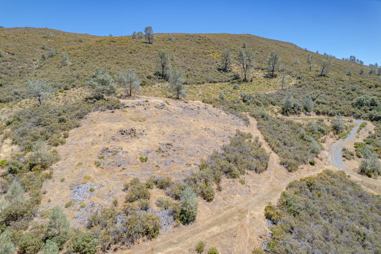 417 Salmon Falls Road El Dorado Hills, CA 95762 - Photo 5 of 47 a view of a dry field with mountains in the background