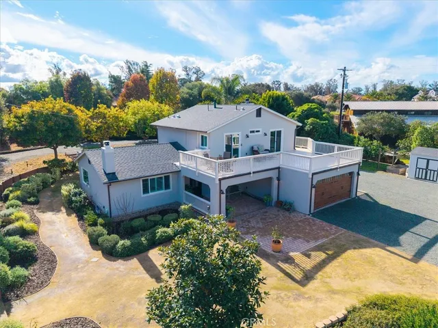 an aerial view of residential houses with outdoor space and swimming pool