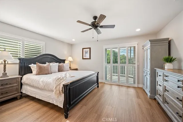a view of a bedroom with wooden floor and a window