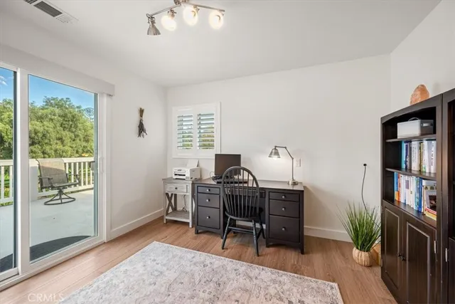 a view of house with a yard and sitting area