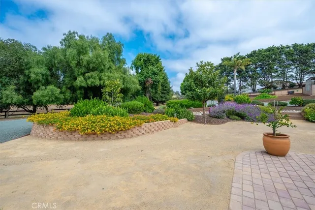 an aerial view of a house with a swimming pool and outdoor seating