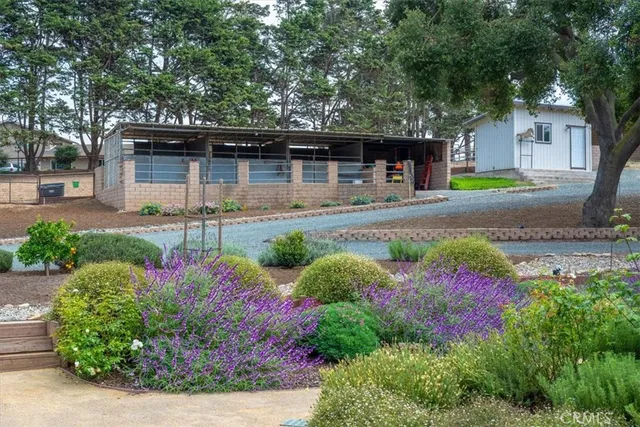 an aerial view of a residential houses with yard