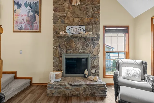 a living room with couches and dining table with wooden floor