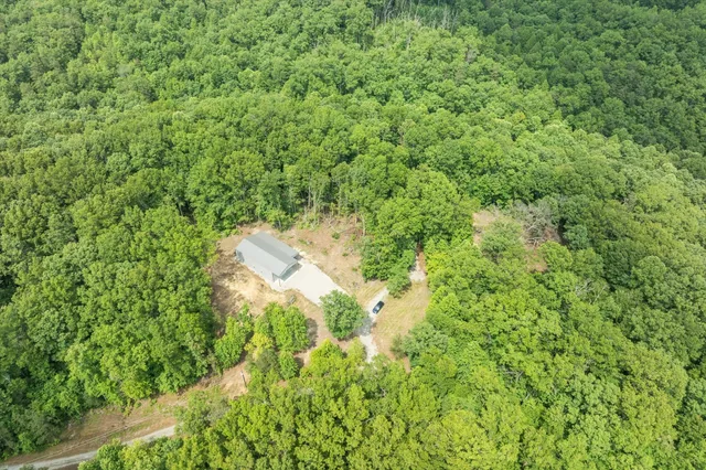an aerial view of a houses with a yard