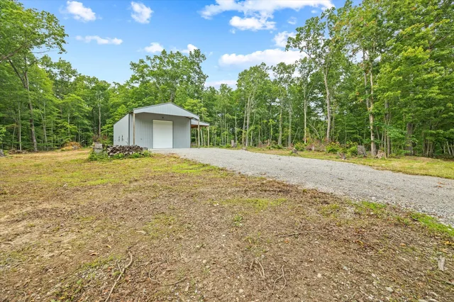 a backyard of a house with large trees