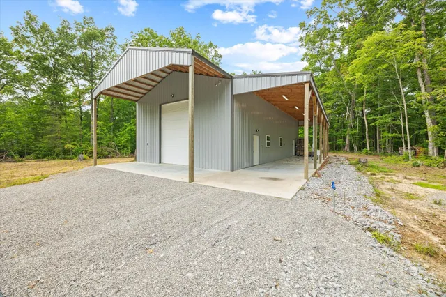 a view of a house with backyard and trees