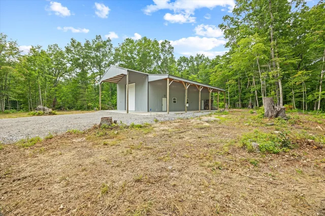 a backyard of a house with large trees and a small yard