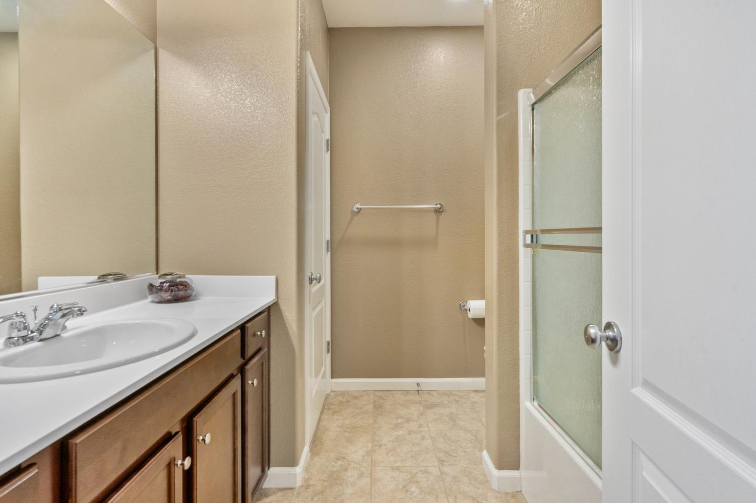 2317 Mathar Drive Manteca, CA 95337 - Photo 40 of 48 a bathroom with a sink and a mirror