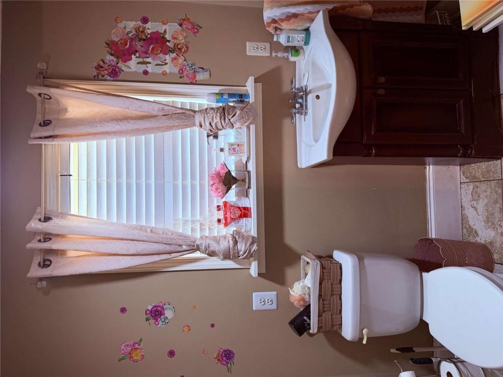 1972 Mt Zion Road Oxford, GA 30054 - Photo 9 of 15 a bathroom with a sink mirror and toilet