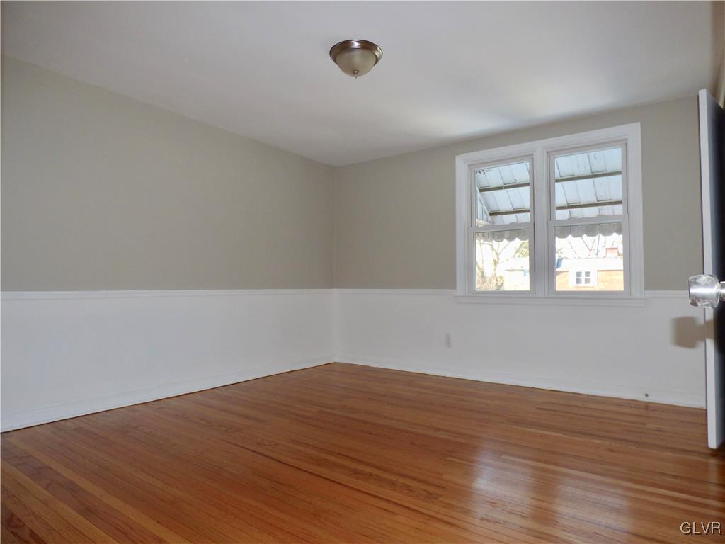 1925 South Delaware Street Allentown, PA 18103 - Photo 14 of 16 wooden floor in an empty room with a window
