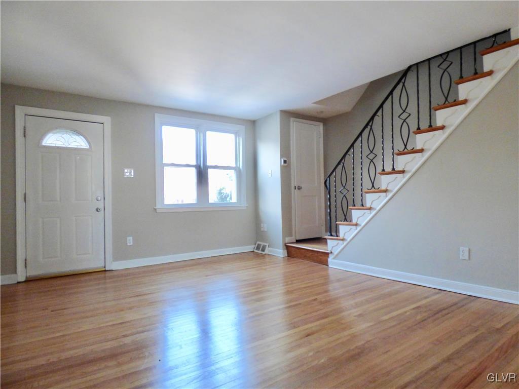 1925 South Delaware Street Allentown, PA 18103 - Photo 4 of 16 a view of an empty room with wooden floor and stairs