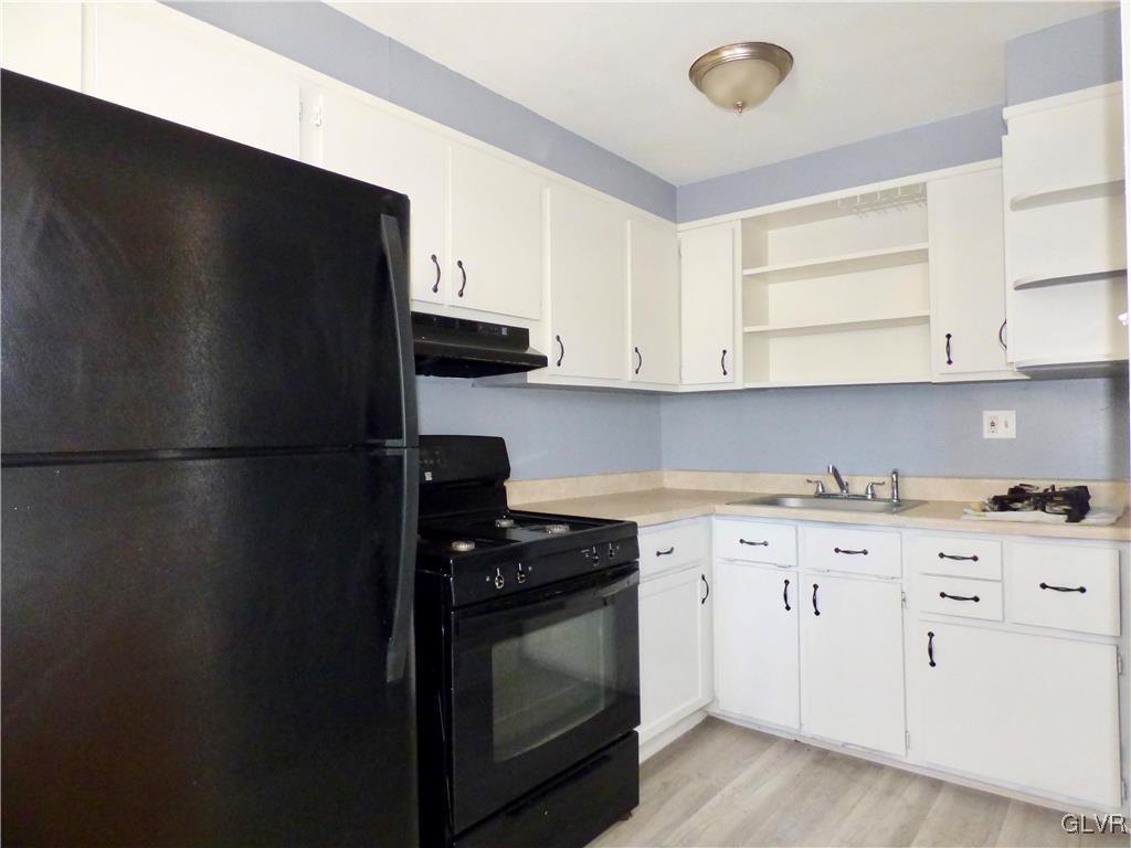 1925 South Delaware Street Allentown, PA 18103 - Photo 6 of 16 a kitchen with a refrigerator stove and white cabinets