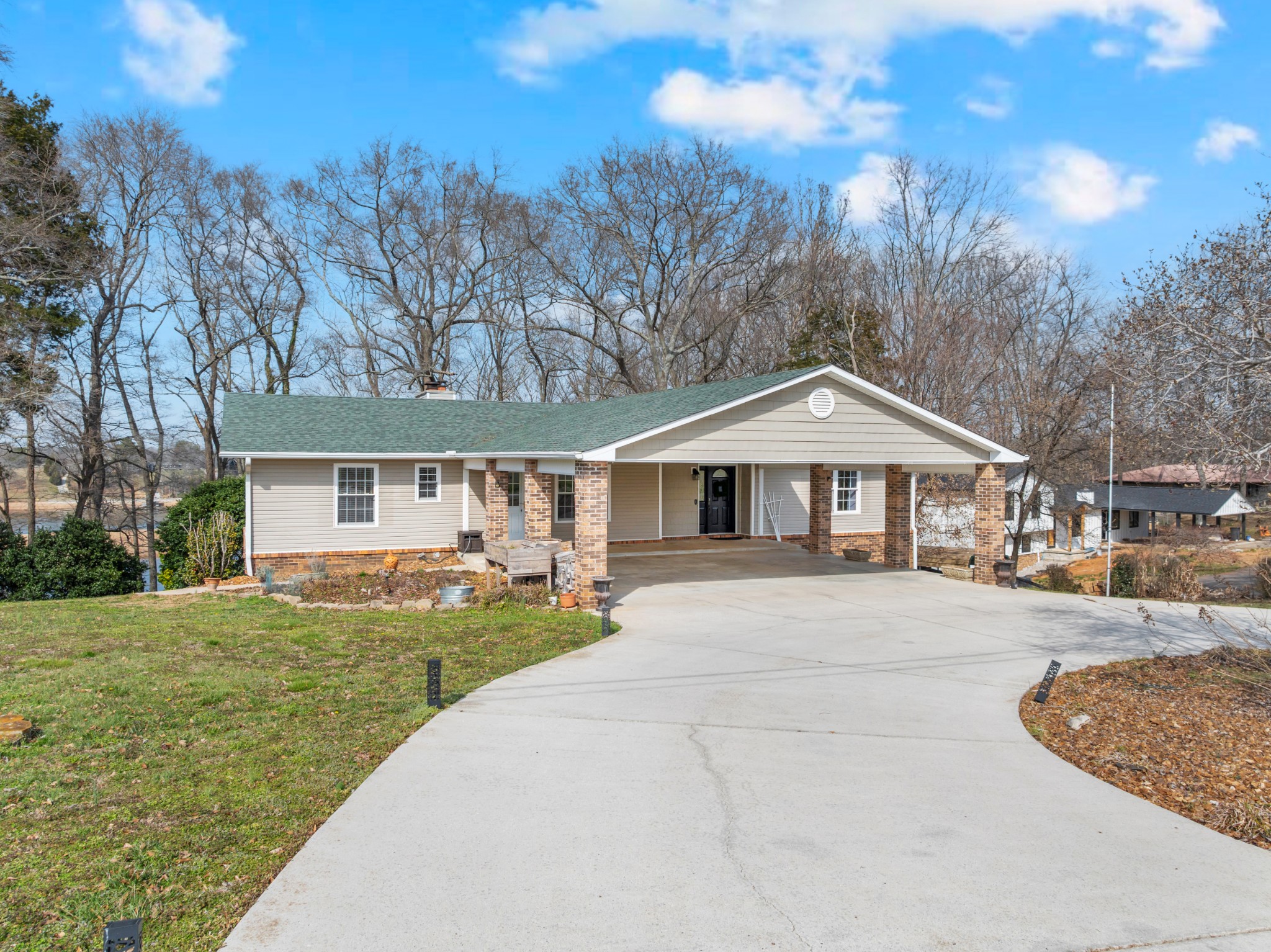 182 Loop Drive Winchester, TN 37398 - Photo 3 of 60 a front view of a house with a garden and trees