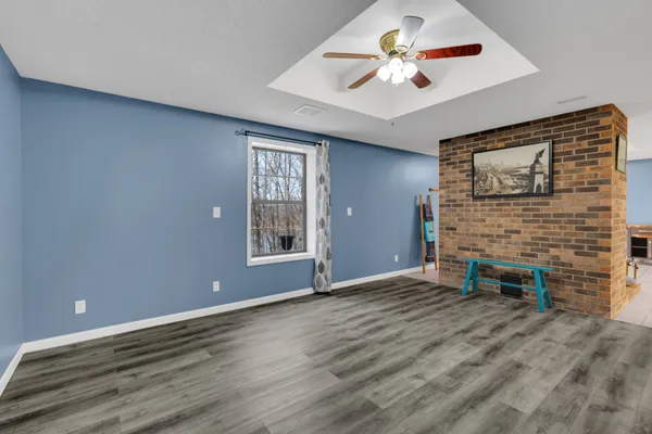 a kitchen with stainless steel appliances granite countertop a table chairs sink and cabinets