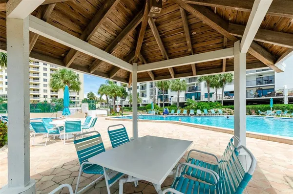 a view of a patio with a table chairs and a backyard