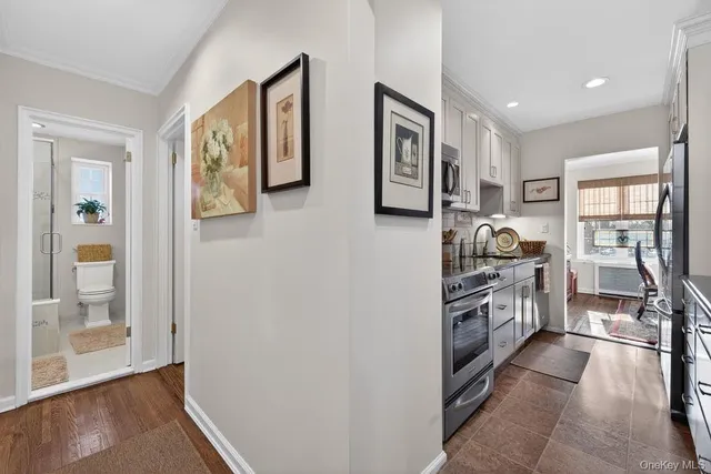 a kitchen with stainless steel appliances granite countertop a refrigerator and a stove top oven