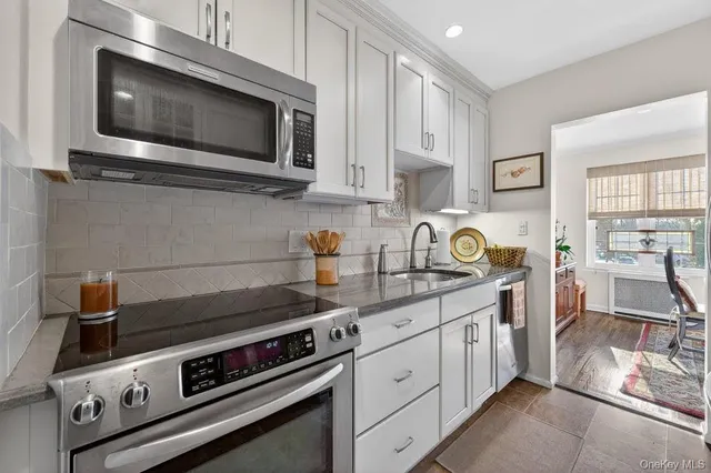 a kitchen with stainless steel appliances a stove a microwave and cabinets