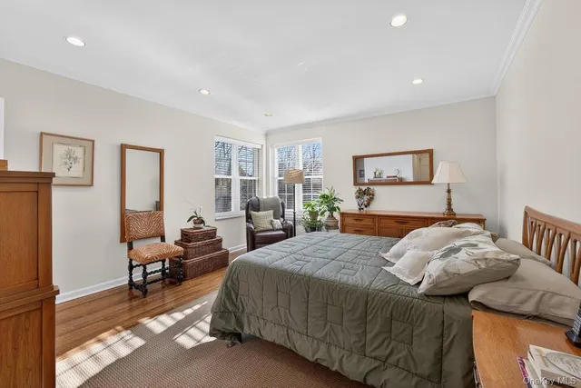 a bed room with a bed furniture and a large window