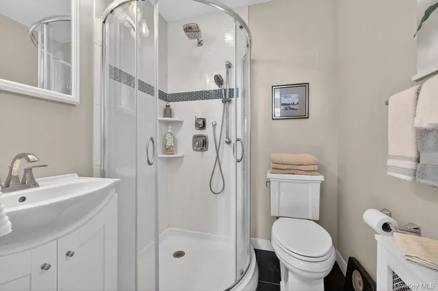 a bathroom with a granite countertop toilet sink and shower