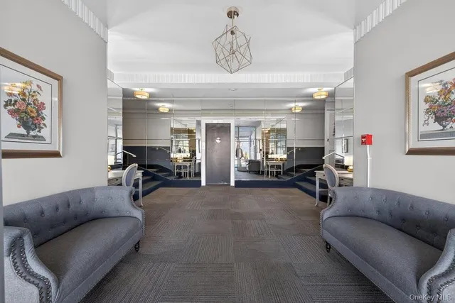 a living room with furniture and a chandelier