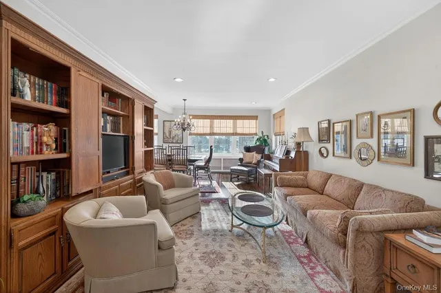 a living room with furniture and a book shelf