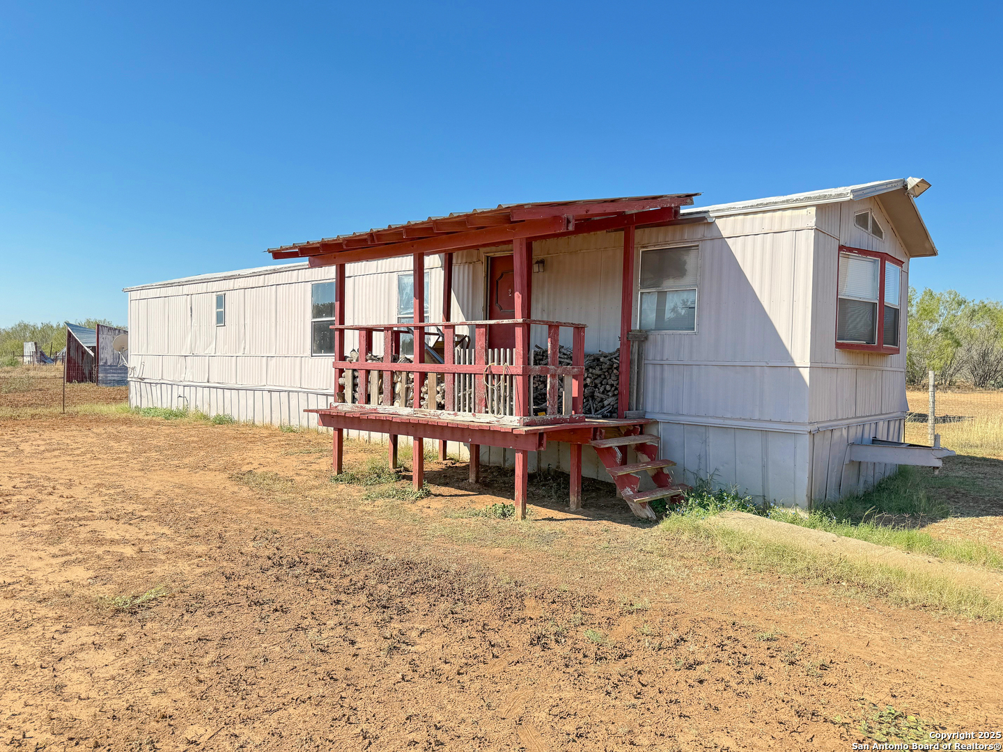 179 Private Road 6624 Devine, TX 78016 - Photo 16 of 20 a view of a house with backyard and sitting area