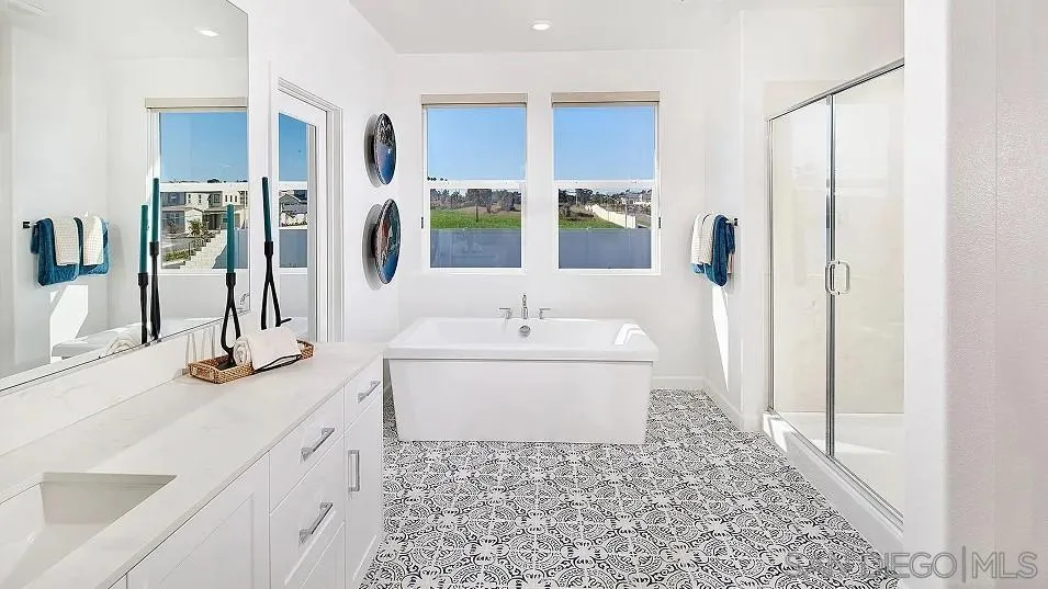 130 Mellano Way Oceanside, CA 92057 - Photo 17 of 26 a bathroom with a tub sink and mirror