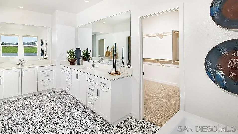 130 Mellano Way Oceanside, CA 92057 - Photo 18 of 26 a bathroom with a sink and a mirror