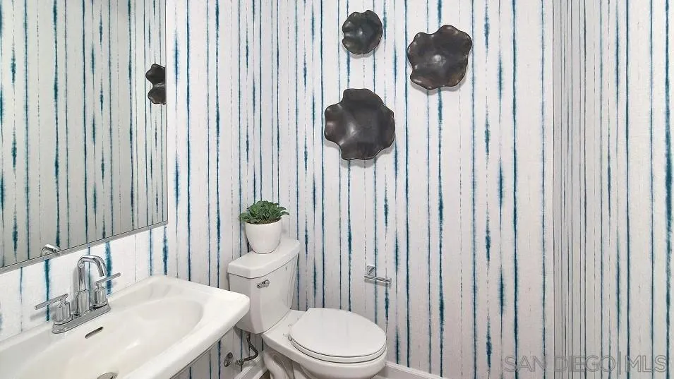 130 Mellano Way Oceanside, CA 92057 - Photo 20 of 26 a bathroom with a sink a toilet and shower