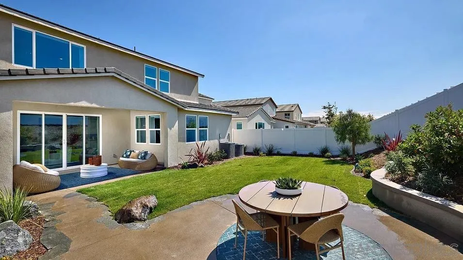 130 Mellano Way Oceanside, CA 92057 - Photo 21 of 26 a view of a house with backyard sitting area and garden