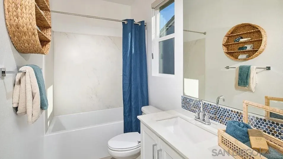 130 Mellano Way Oceanside, CA 92057 - Photo 10 of 26 a bathroom with a sink a toilet and a mirror