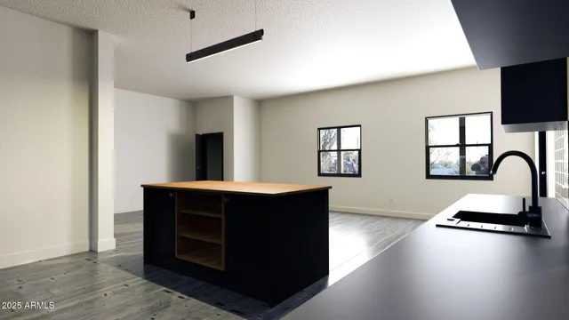a kitchen with a stove cabinets and a wooden floor