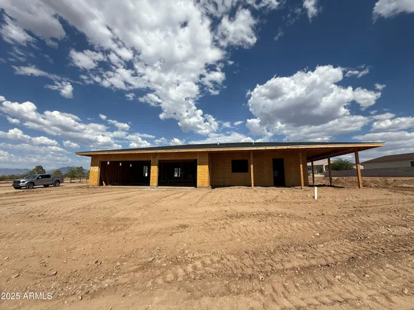 a front view of house with yard and trees