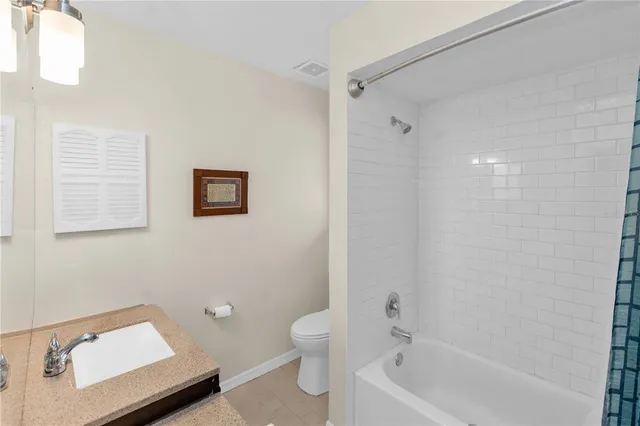 a bathroom with a tub shower and sink