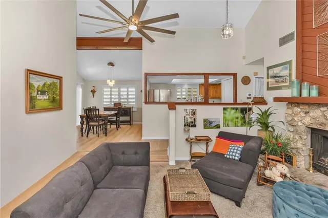 a living room with fireplace furniture and a chandelier