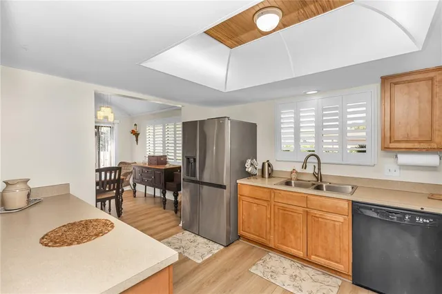 a kitchen with sink a refrigerator and cabinets