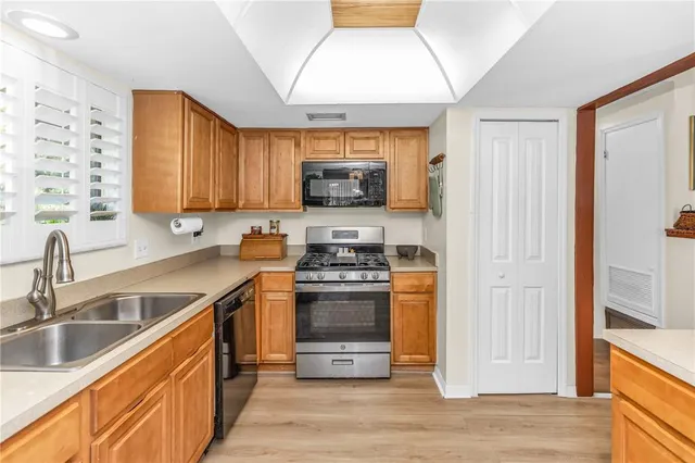 a kitchen with stainless steel appliances granite countertop a stove and a sink