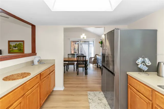 a kitchen with stainless steel appliances granite countertop a refrigerator a stove and a sink