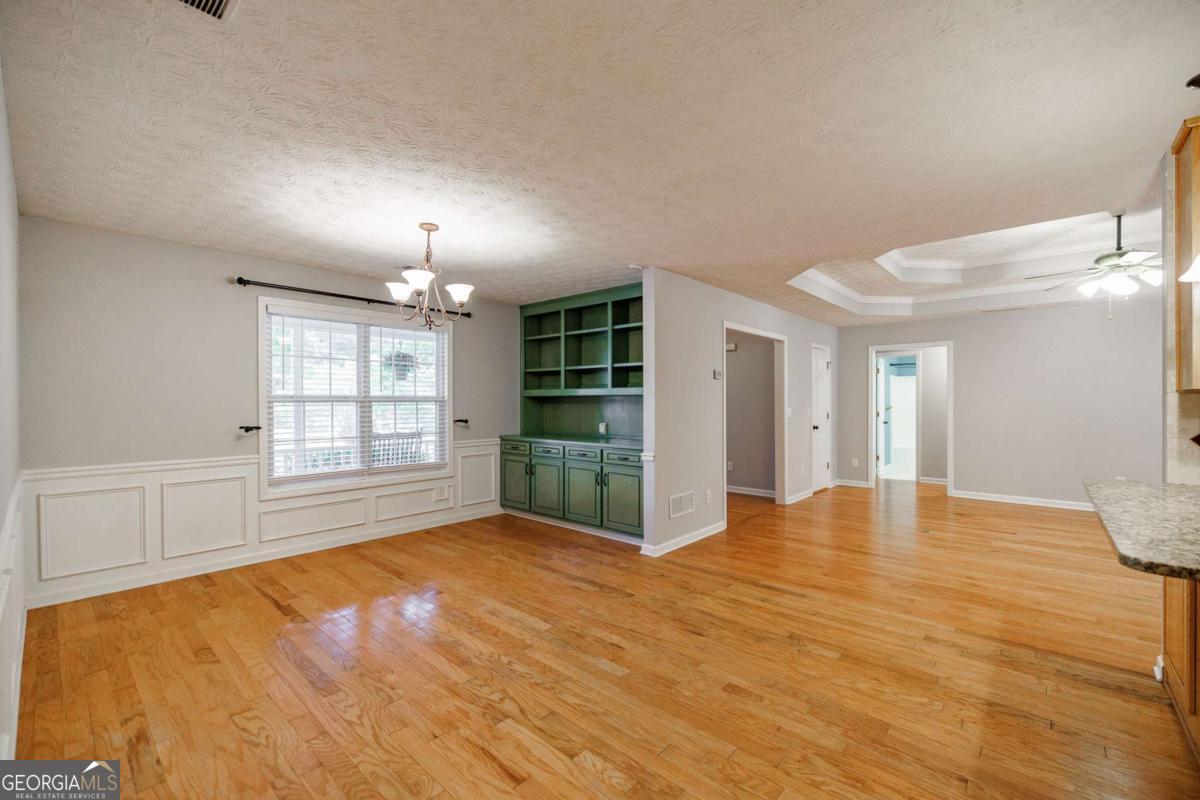 2249 Cluster Lane Grayson, GA 30017 - Photo 11 of 53 a view of an empty room with window and wooden floor