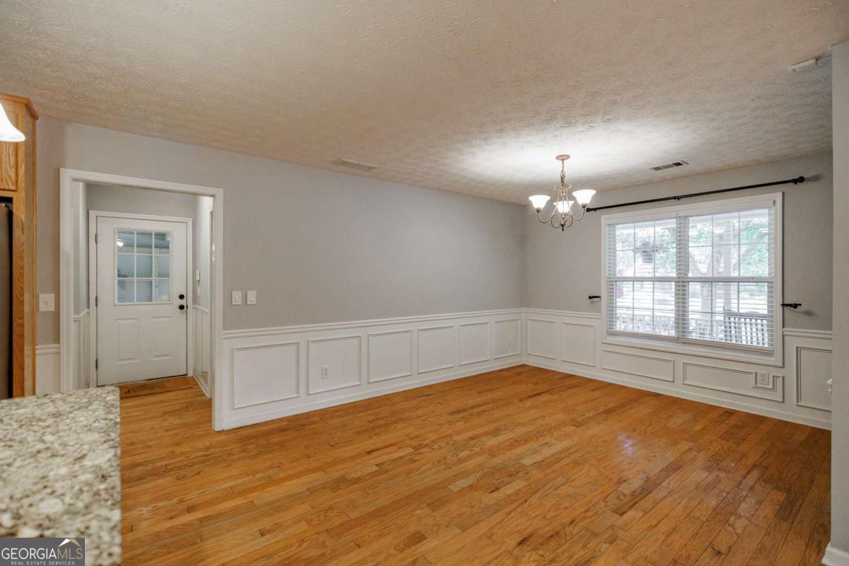 2249 Cluster Lane Grayson, GA 30017 - Photo 13 of 53 an empty room with wooden floor and windows