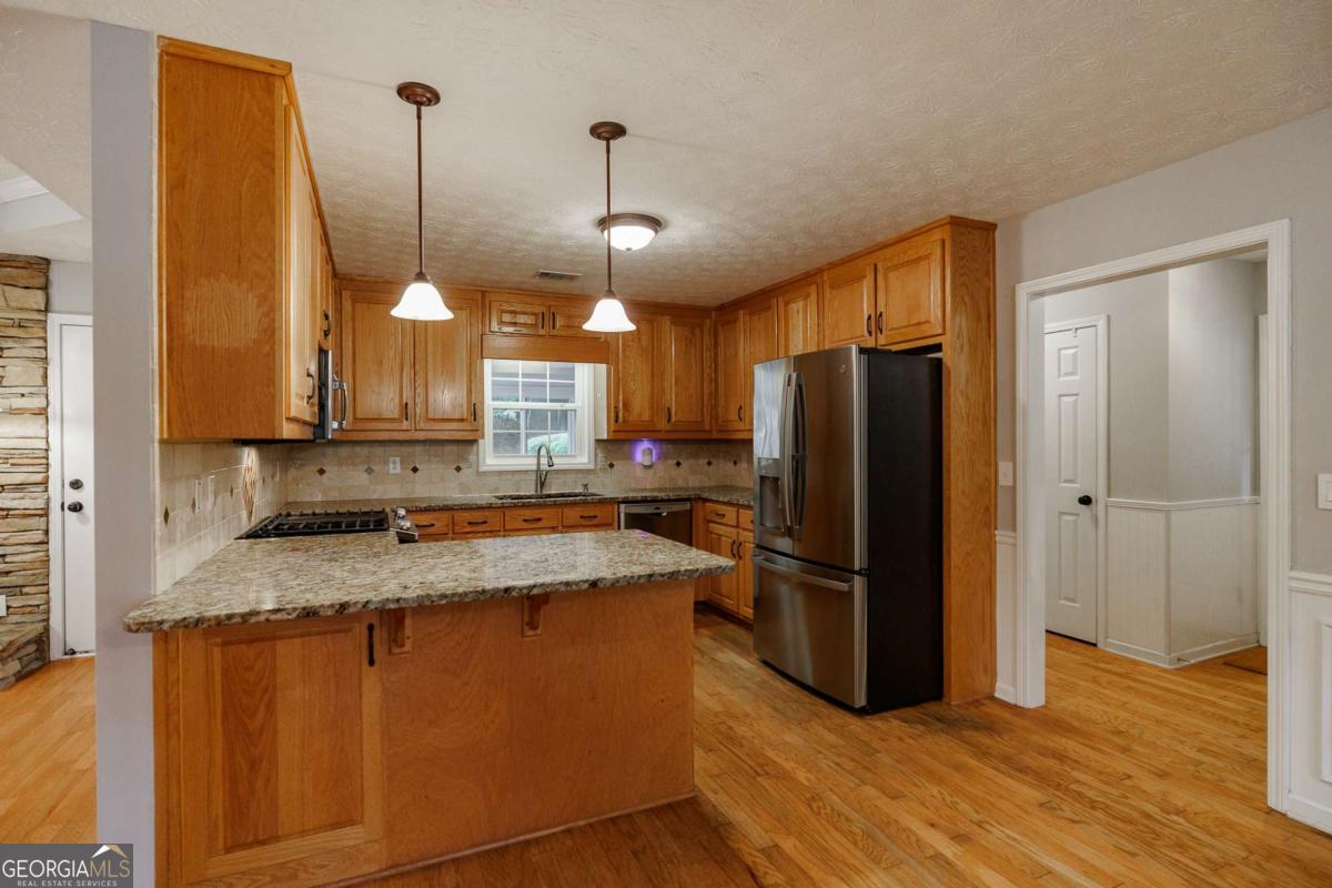 2249 Cluster Lane Grayson, GA 30017 - Photo 14 of 53 a kitchen with stainless steel appliances granite countertop a refrigerator a sink and a stove