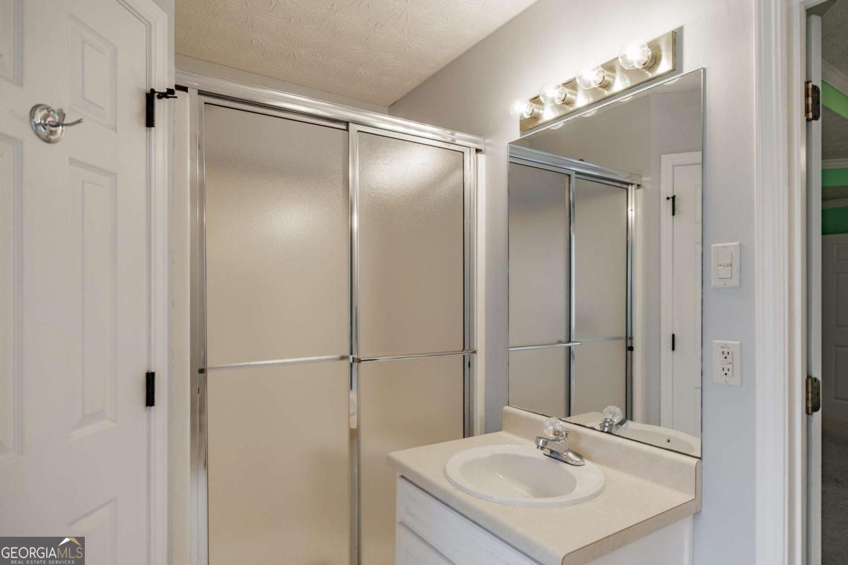 2249 Cluster Lane Grayson, GA 30017 - Photo 20 of 53 a bathroom with a sink and a mirror