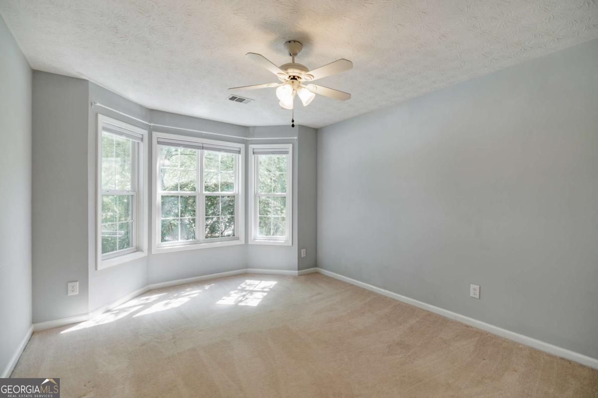 2249 Cluster Lane Grayson, GA 30017 - Photo 23 of 53 a view of a livingroom with a ceiling fan and window