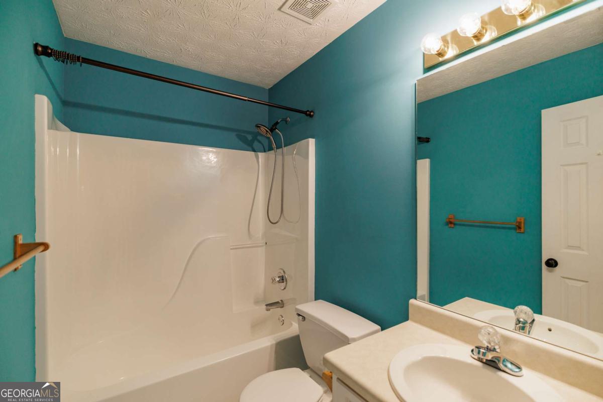 2249 Cluster Lane Grayson, GA 30017 - Photo 25 of 53 a bathroom with a sink and toilet