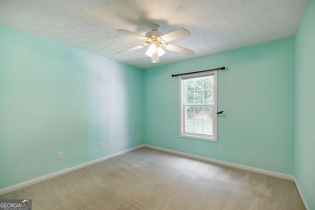 2249 Cluster Lane Grayson, GA 30017 - Photo 26 of 53 an empty room with windows and fan
